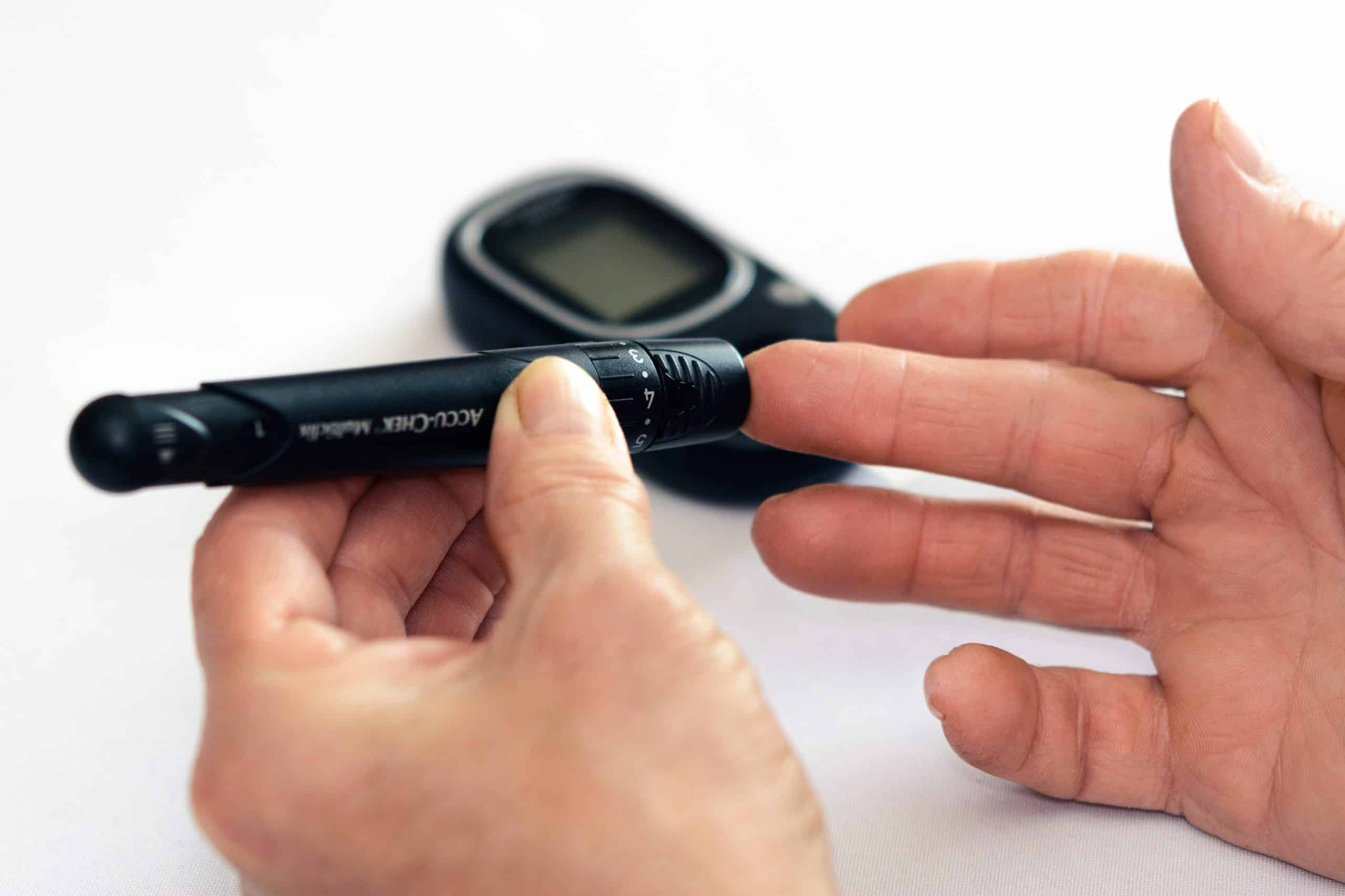 Person measuring blood sugar for diabetes